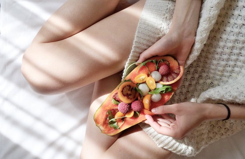 person holding papaya fruit on bed 5 great ways to start your morning to ensure you have a fabulous day