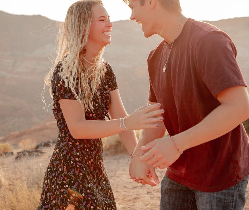 excited couple having fun in desert in summer EXPRESS YOUR LOVE